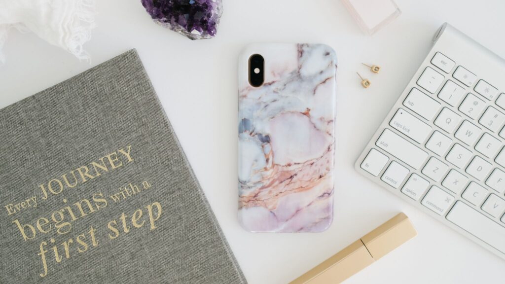 A desk with a journal. The cover reads "Every Journey begins with a first step"